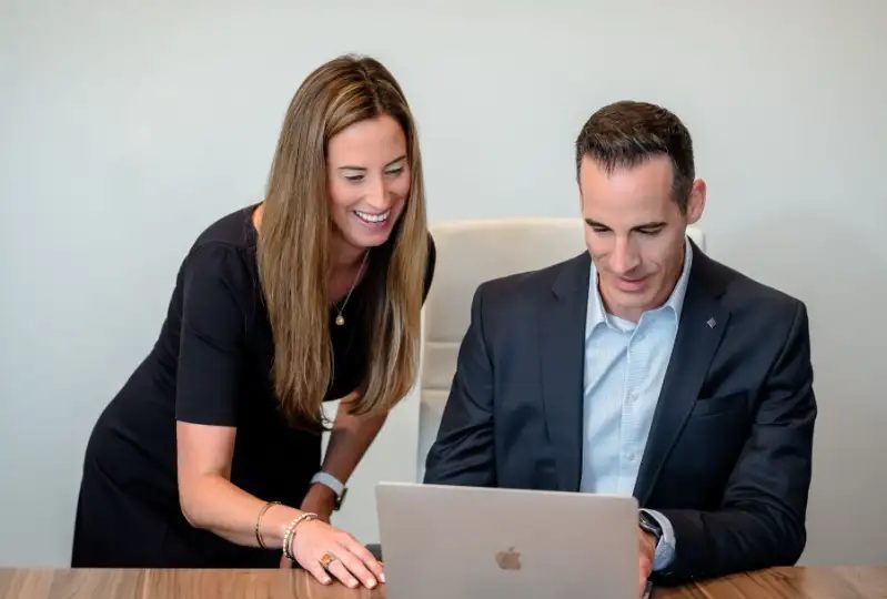 Two Hockfield team members reviewing data on a laptop